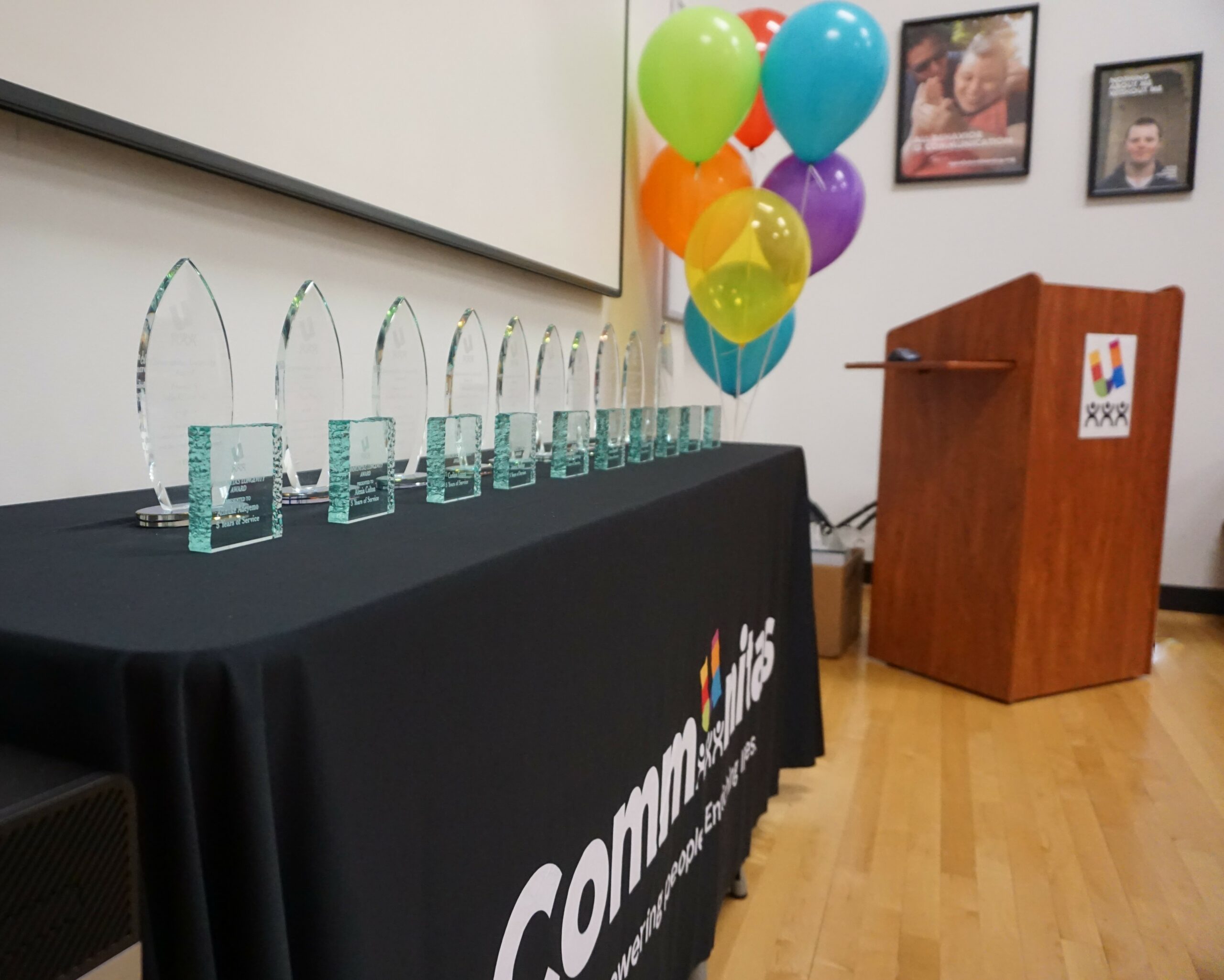 table of awards, with colorful balloons at the end
